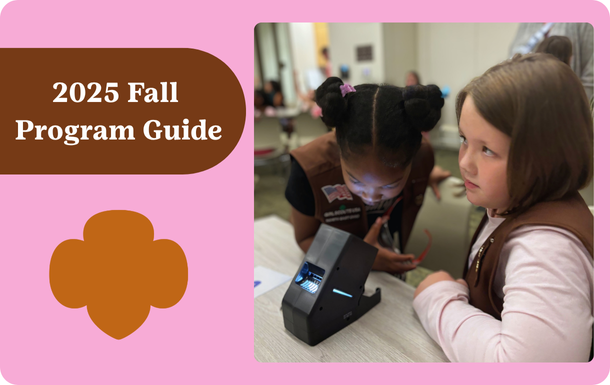Text on left saying Fall Program Guide, photo of Brownies looking through a microscope